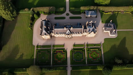 aerial view of a grand stately home and formal gardens