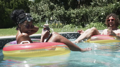 diverse couple, a young african american woman and caucasian man, enjoy pool time