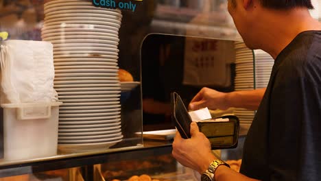 man purchasing dessert at hong kong bakery