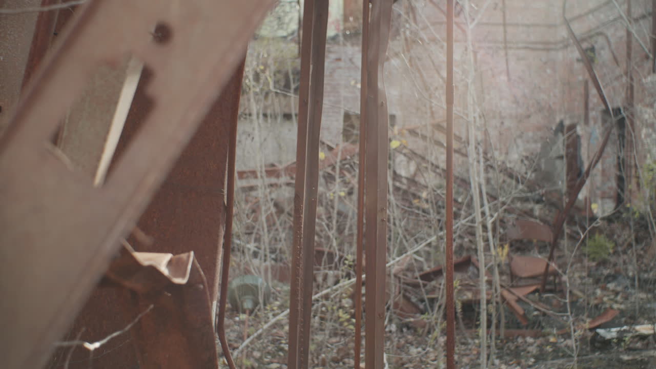 Panning shot of rusty beams glimmering against the sun