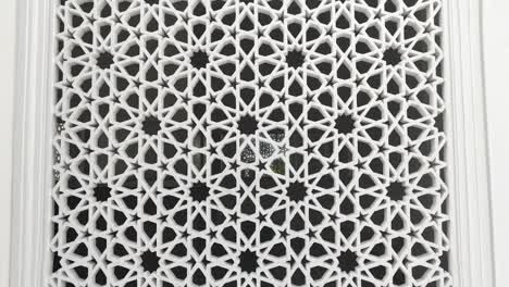 a building with islamic geometric patterns as architectural elements for ventilation, lighting, and privacy, blocking outside views while enhancing aesthetics.