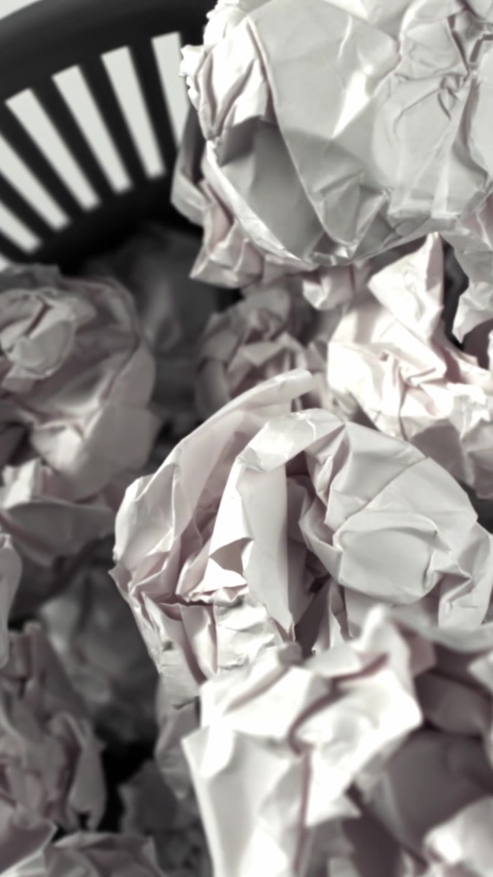 Close-up of Crumpled Paper in a Wastebasket with Focus Transition