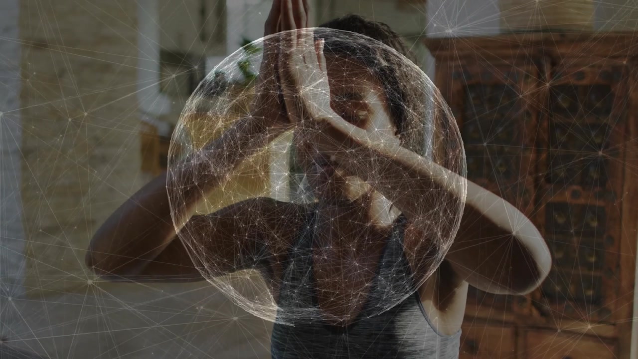 woman raising arms upward with spherical network graphic lowering arms into heart pose for wellness
