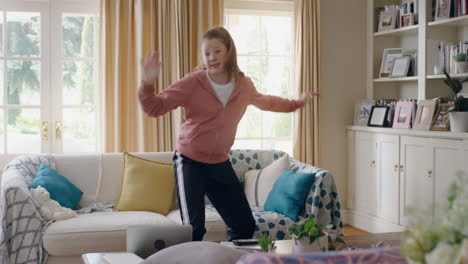 happy teenage girl dancing at home having fun celebrating with cool dance moves playfull falling on sofa enjoying freedom on weekend 4k