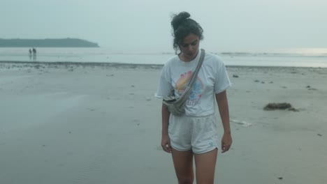 a woman walking along the beach