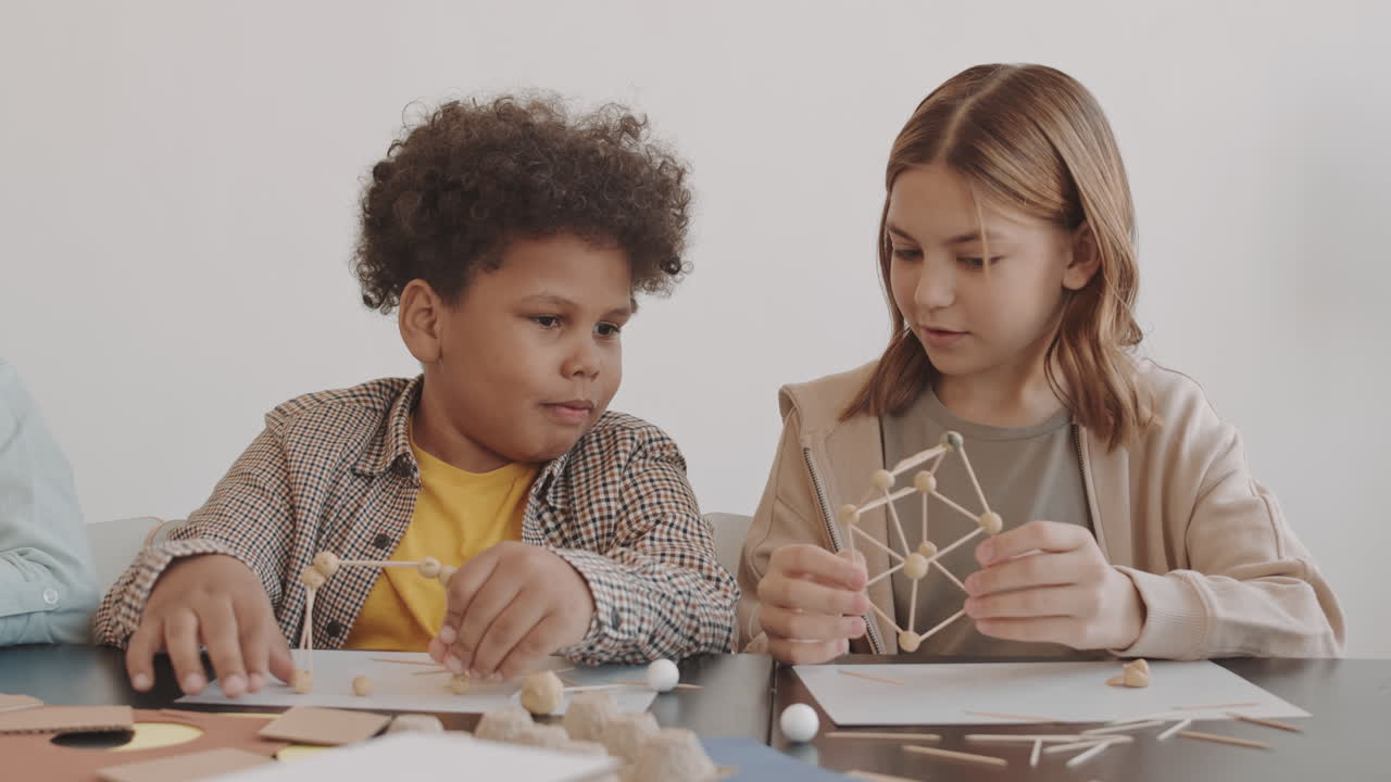 Girl Showing Craft to Boy