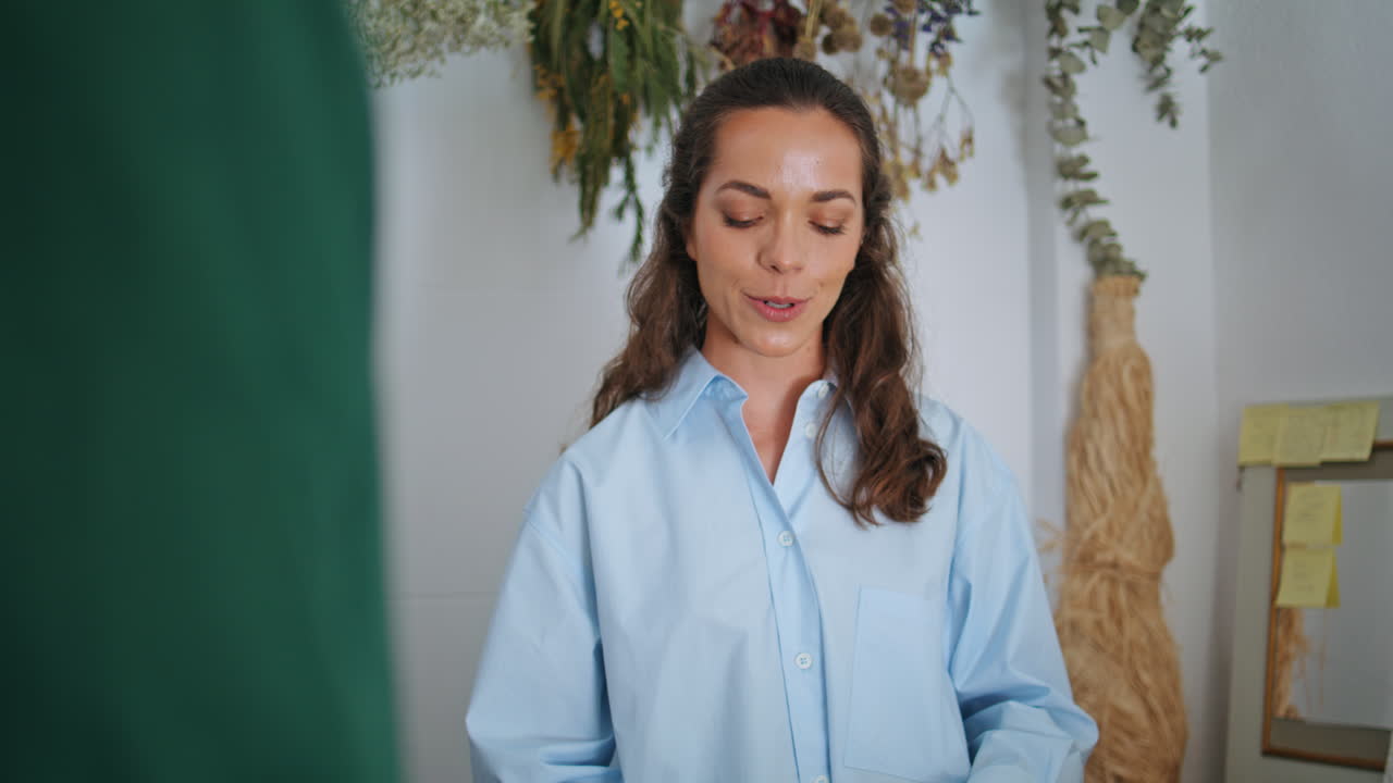 florista alegre mujer venden flores en la tienda. chica bonita hacer ramo en el trabajo