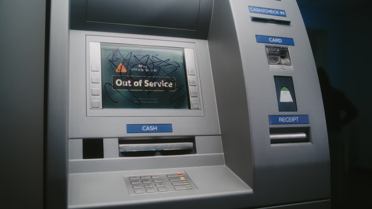 Unrecognizable Person Marking ATM Screen with Graffiti with Marker. Vandal Causing Property Damage, Vandalizing Out of Service Cash Machine with Illegal Graffiti. Vandalism of Public Banking Equipment