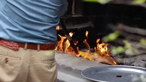 man managing fire in outdoor setting