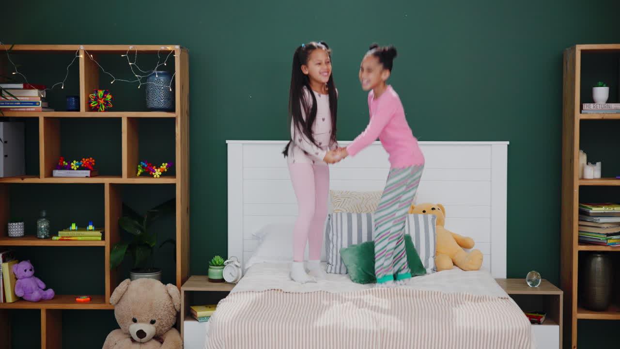 Two Girls Jumping on Bed in Pajamas