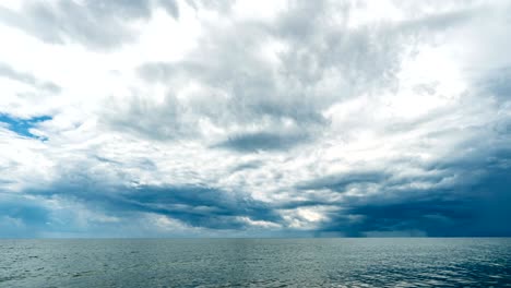4k time lapse of the sea and blue sky, white clouds evolve and change shape, dynamic weather, beautiful seascape, video loop