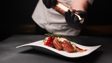 chef seasoning a delicious bacon and vegetable dish