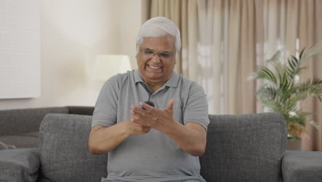 Angry-Indian-old-man-trying-to-fix-TV-Remote