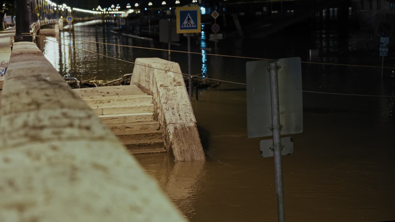 Partially submerged staircase and traffic signs in floodwaters during the Budapest Flood 2024