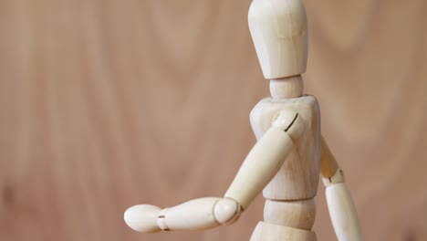 wooden figurine walking on wooden floor