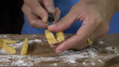 woman chef hand cut out cookie dough into squares