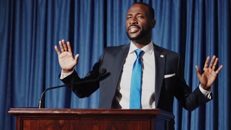 man giving a speech at a podium