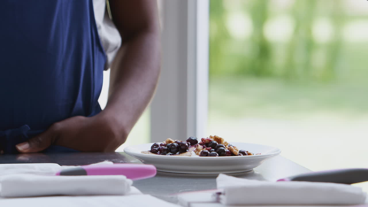 Close Up Of Woman Taking Photo Of Meal On Mobile Phone For Social Media In Cookery Class