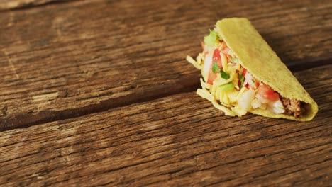 video of freshly prepared tacos lying on wooden background