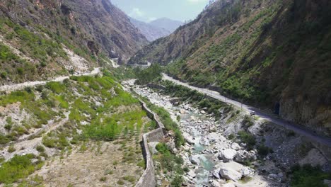 drone shot of a small road and river in himachal pradesh near manali, kasol-4