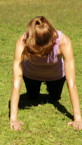 mujer haciendo flexiones en el parque