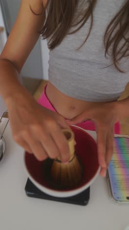 person preparing matcha tea at home