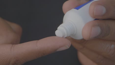 applying cream to finger