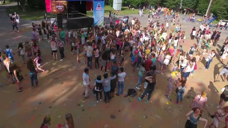 festival of color in a city park. vinnitsa, ukraine - july 2017: people have fun during the festival of color in a city park in vinnitsa