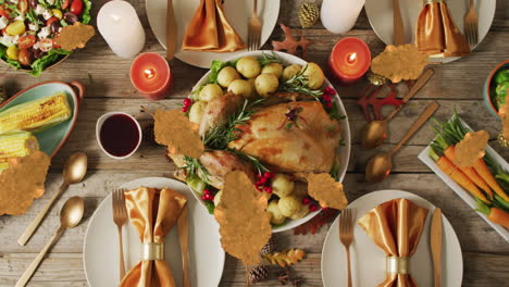 animation of autumn leaves over thanksgiving dinner background