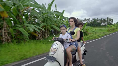 family riding motorcycle along asphalt road