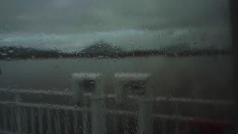 Looking-Through-Wet-Glass-Window-Of-Ferry-Boat-Cruising-In-The-Sea