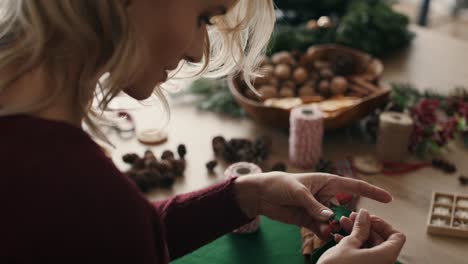Blonde-woman-making-Christmas-decorations-at-home