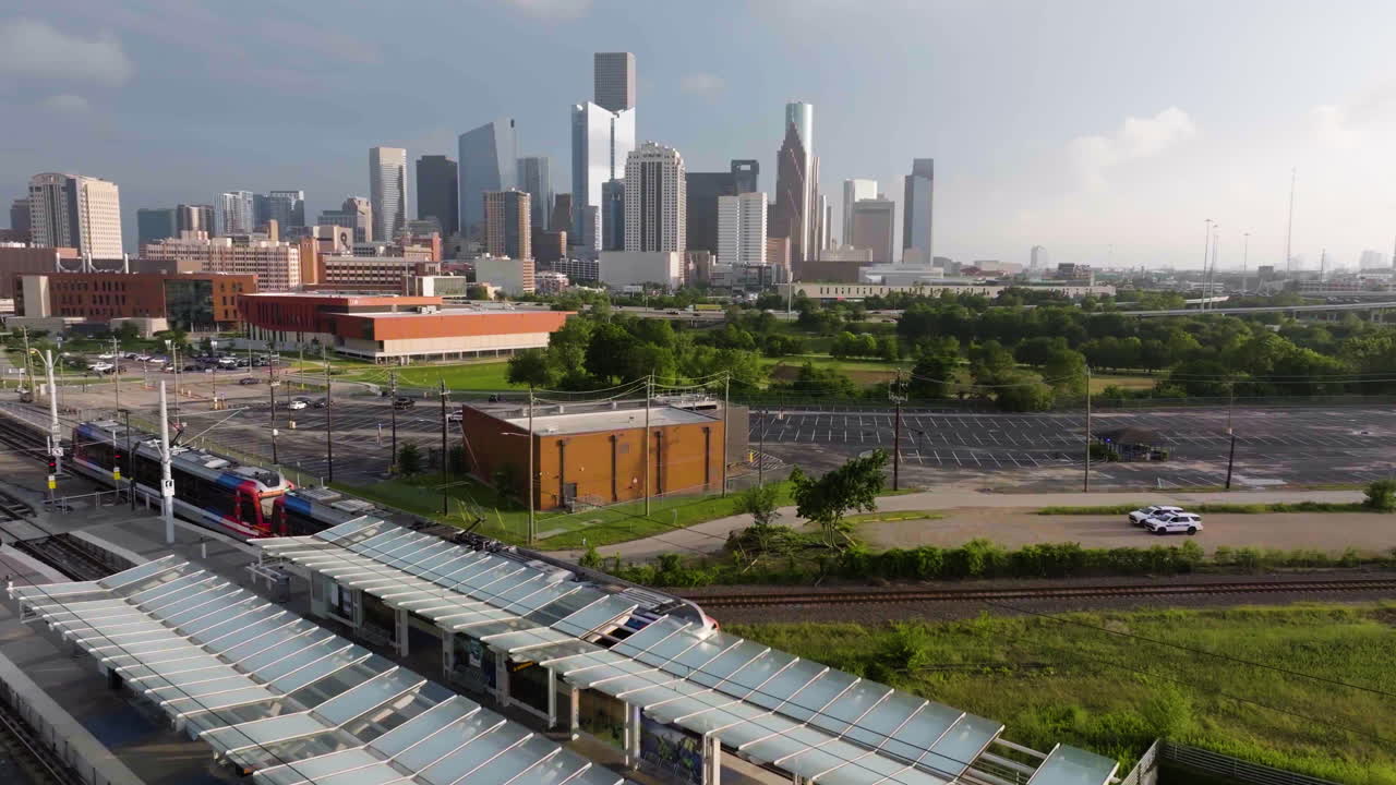 Aerial view of the Metro leaving the station with downtown Houston background