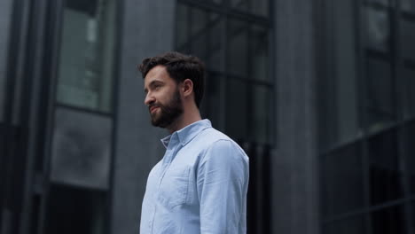 portrait successful bearded businessman standing at modern business center.