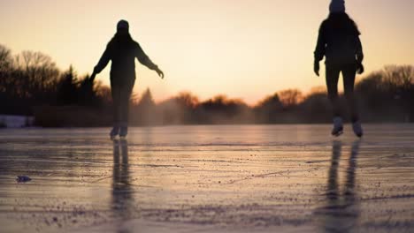 skaters gliding gracefully across the icy surface at dusk, capturing the essence of winter's beauty and the joy of ice skating under a colorful sky