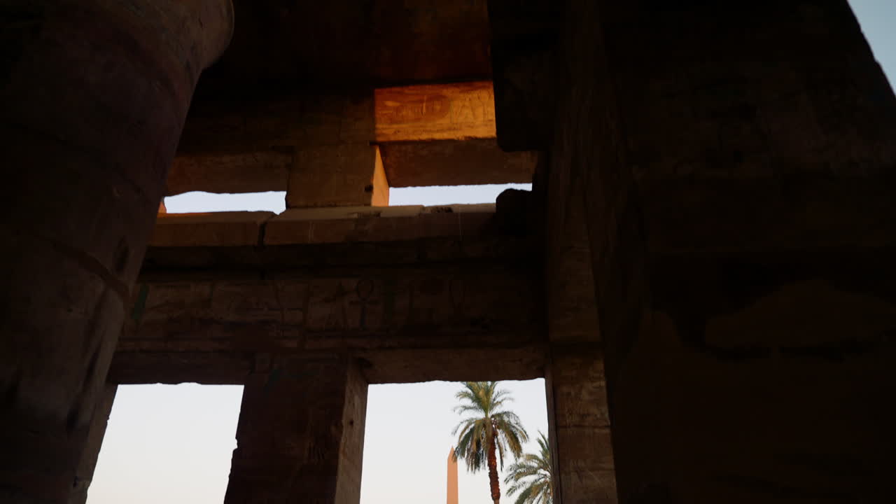 Obelisk At Karnak Temple Complex At Sunrise In Luxor, Egypt. dolly-in, tilt-down reveal