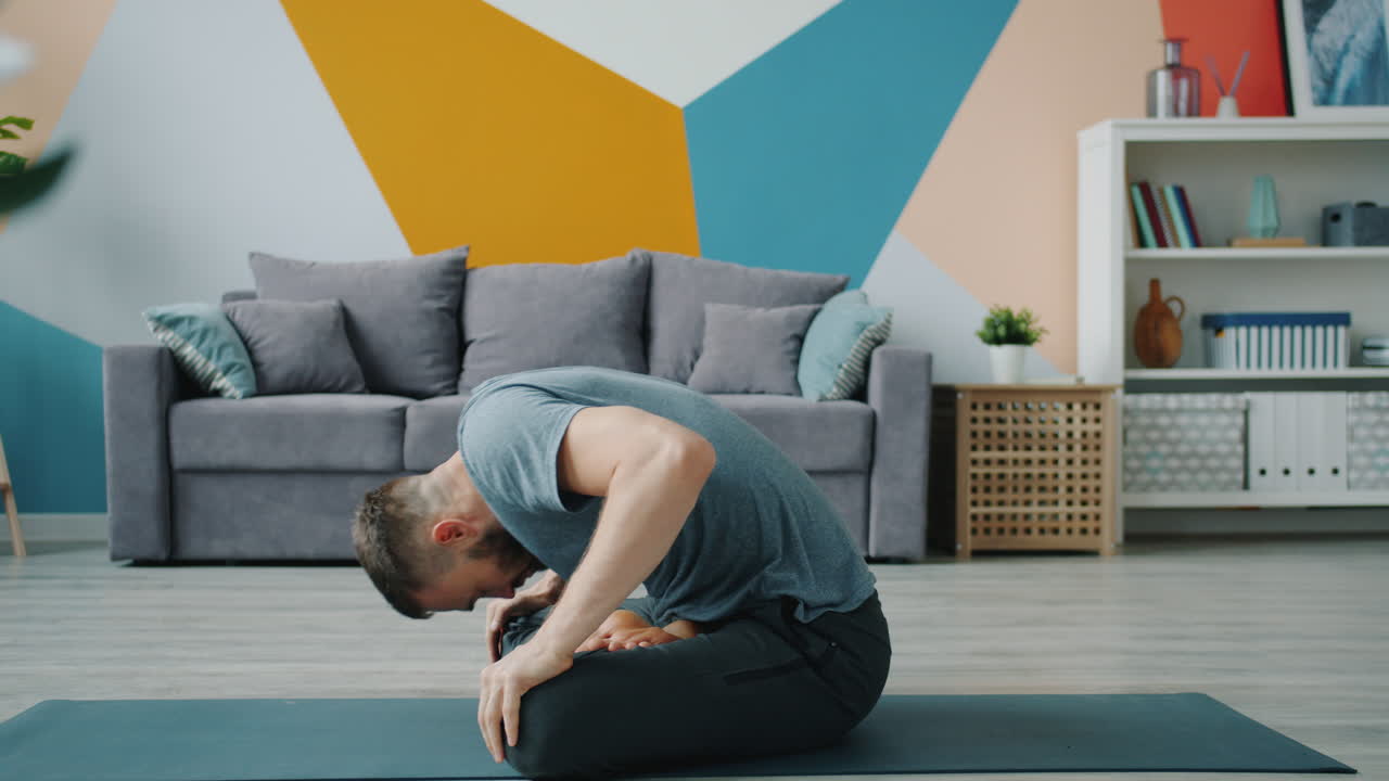 Man Doing a Seated Yoga Stretch at Home