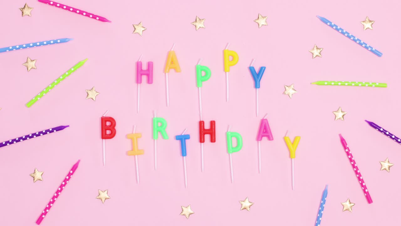 Happy birthday candles move on pink theme with colorful cake candles and golden stars. Stop motion