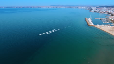 two jet ski scooters ride by the blue waterscape. fun water sport activities in summer at the seaside. aerial view