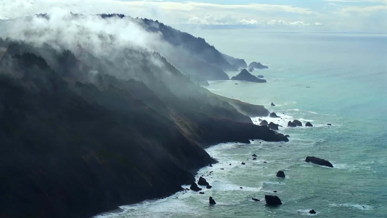 Rugged coastline Lost Coast Trail USAL Beach campground 4wd black sand mist rain fog aerial drone California PNW sun rays waves crashing cloud layer morning Chimney Rocks scenic flight circle right