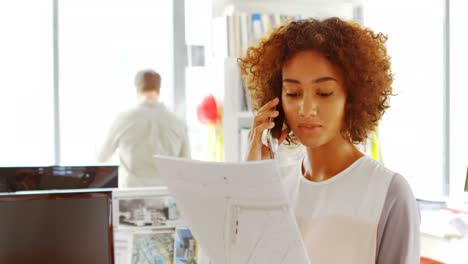 Female-architect-talking-on-mobile-phone-4k