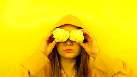 fancy caucasian model with fresh vegetables on eyes. stop motion looped.