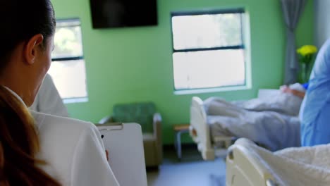 female doctor writing on clipboard 4k