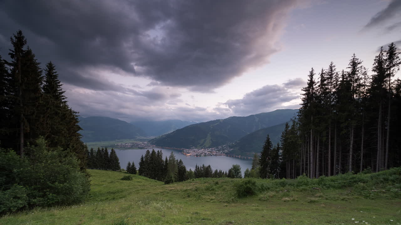 Best view of Zell am See Kaprun, Austria. Day to night timelapse from a mountain above the city and the lake