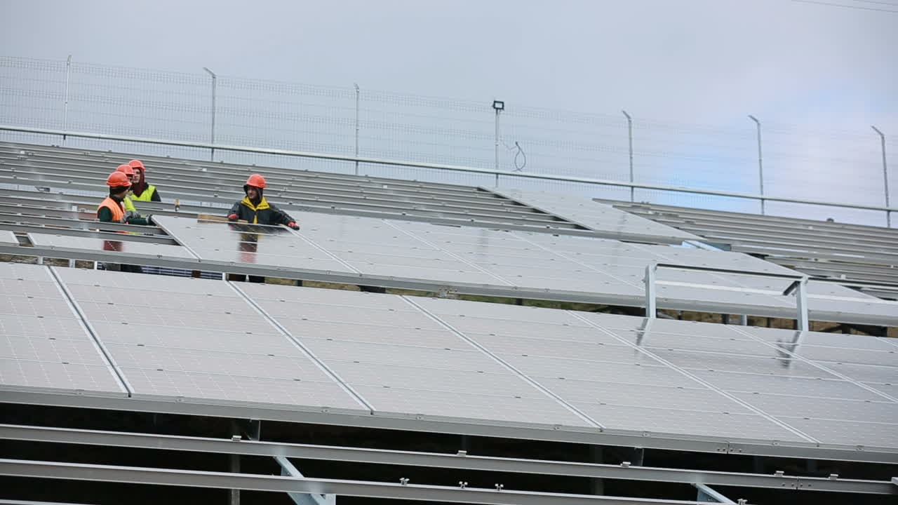 Men working at solar station. VINNITSA, UKRAINE - NOVEMBER 2017: Solar panel technician installing solar panels