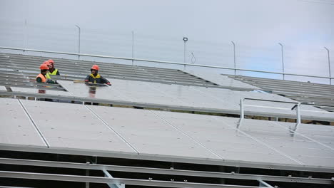 men working at solar station. vinnitsa, ukraine - november 2017: solar panel technician installing solar panels
