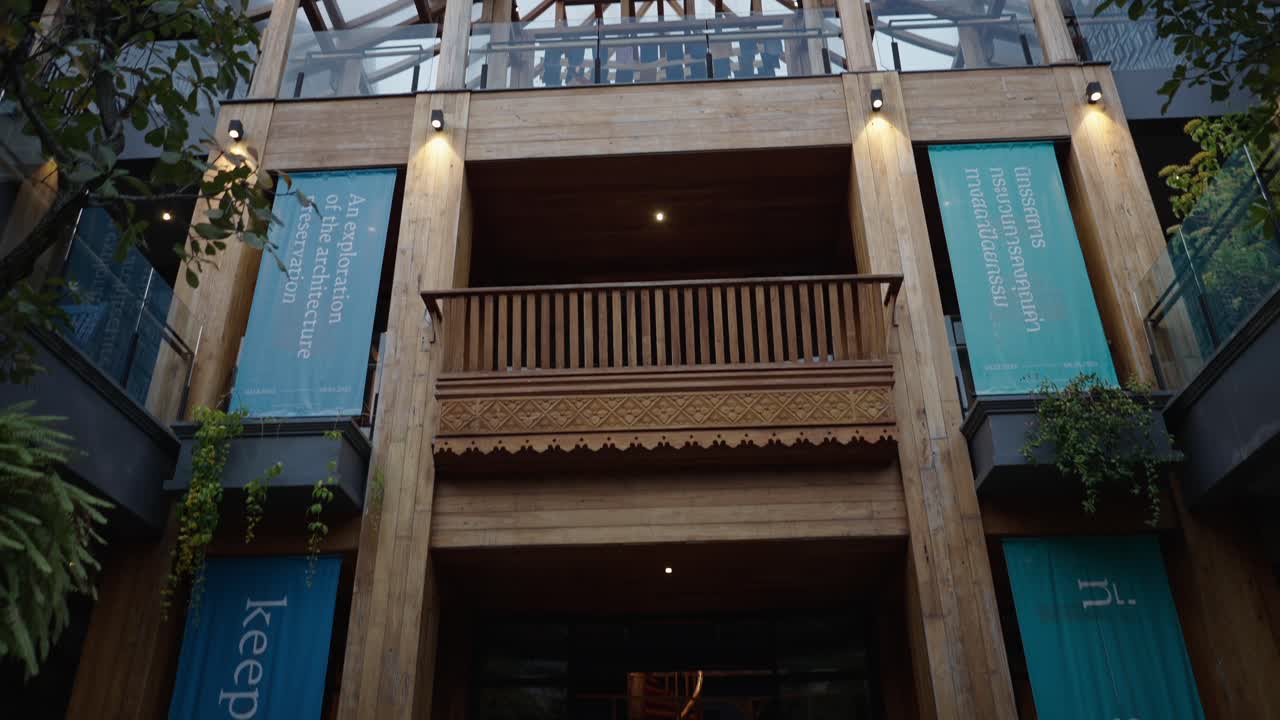 Modern Wooden Building with Glass Roof and Architectural Exhibition Banners