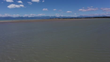 Aerial-flyover-mudflats-towards-sandbar-and-tussocks-on-a-beautiful-sunny-day