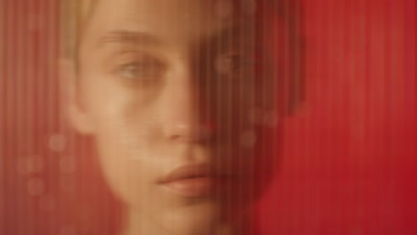 woman behind a red screen