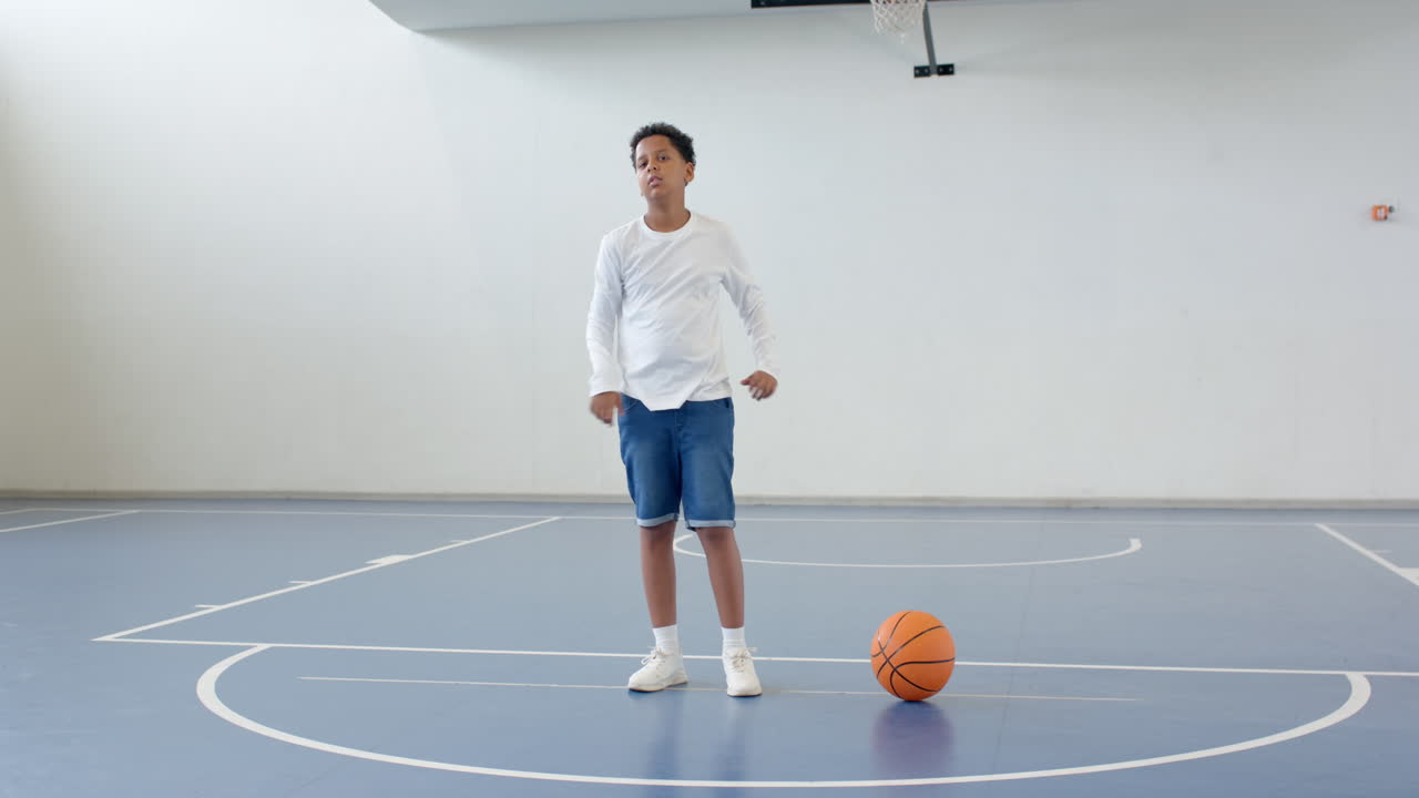 boy stretching on basketball court, preparing for practice, copy space